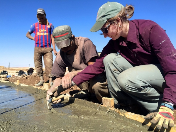 E309_Intro_Columbia_University_Water_Ilguiloda,_Morocco_Aug_2015_community_member_Mohammed_teaches_EWB-USA_Columbia_University_member_Madison_how_to_smooth_concrete-min.jpg